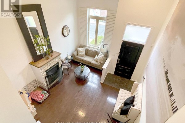 Another angle of the kitchen showing a dining area with glass table and tiled floor. - 287 Kingswood Road, Toronto