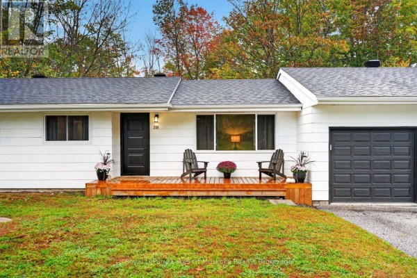 Close-up of the front entrance with a black door, wooden porch, and two chairs. - 288 Musquash Road, Gravenhurst)