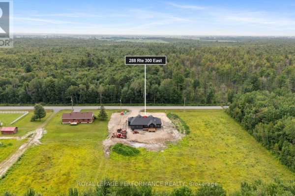 New construction home at 288 Rte 300 East with construction equipment on a rural lot.