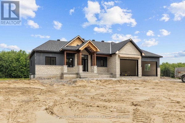 Front view of a new house under construction with unfinished garage doors. - 288 Route 300 East Route, The Nation