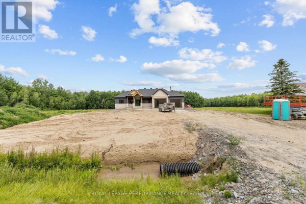 House under construction on a sandy lot with trailer and portable toilet - 288 Route 300 East Route The Nation