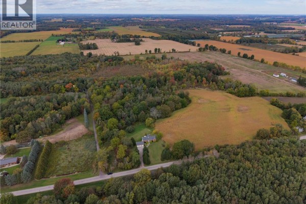 Aerial perspective of the property and surrounding agricultural fields, showcasing the size and location of the residence. - 288 Thirteenth Concession Road, Scotland
