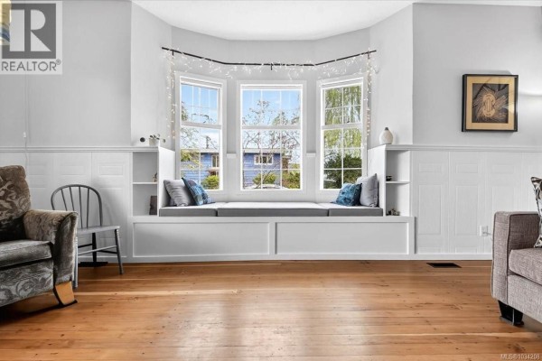 Bay window with a built-in seating area and shelves in a living room. - 2880 1st Ave, Port Alberni