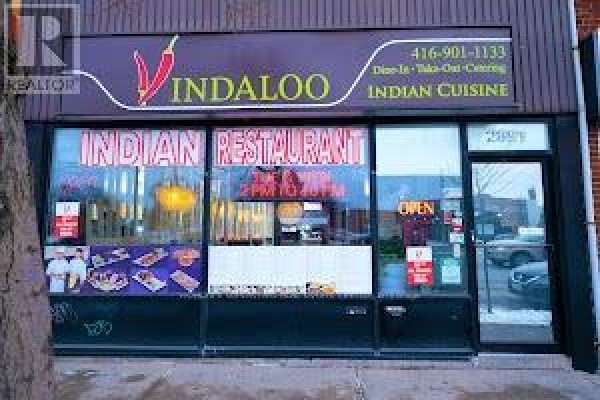 Street view of the commercial building at 2891 Kingston Road with "Indaloo Indian Cuisine" signage and storefronts. - 2891 Kingston Road, Toronto
