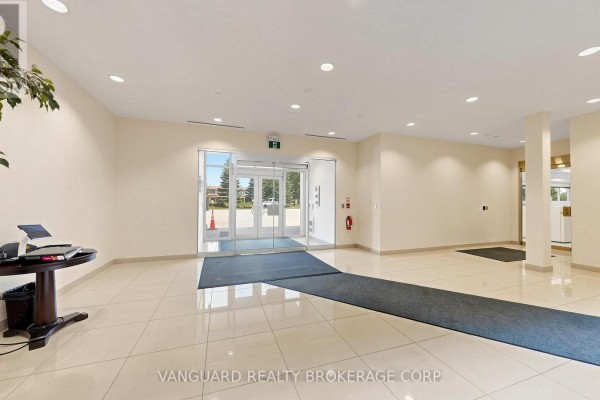 Interior lobby of a commercial building with beige walls and tiled floors. - 2891 Langstaff Road, Vaughan