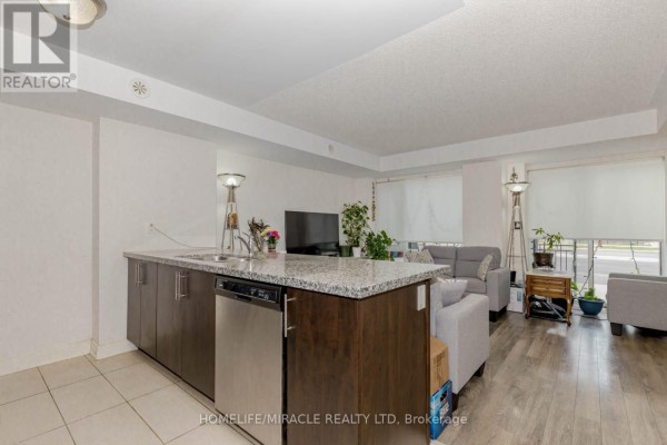 Entryway with wooden display cabinets and doors leading to other rooms. - 29 - 100 Dufay Road, Brampton