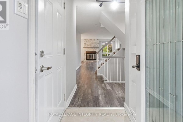View from inside the front door looking into the hallway and living area with a fireplace. - 29 - 1080 Ormes Place, Ottawa