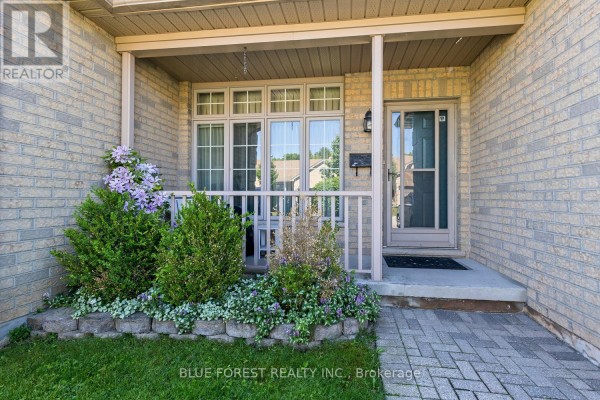 Covered front porch entrance with a glass storm door, windows, and plants. - 29 - 7 Cadeau Terrace, London South