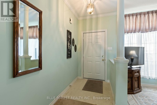 Interior entrance hallway with pale green walls, beige tile floor, and a mirrored wall. - 29 - 7 Cadeau Terrace, London South