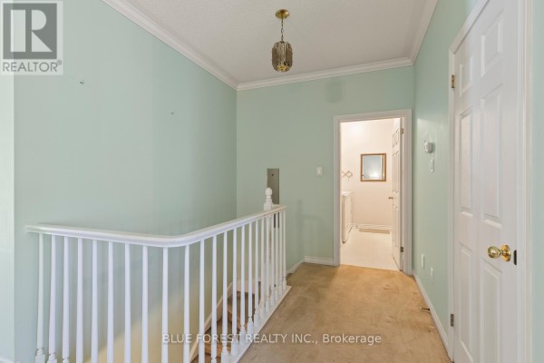 Hallway at the top of stairs with pale green walls and white railing. - 29 - 7 Cadeau Terrace, London South