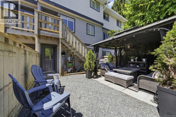 Backyard patio area with grey gravel, outdoor seating, and a gazebo. - 29 3242 Cowichan Lake Rd, Duncan