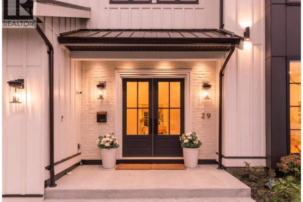 Close-up of the front double entry doors with sidelights and white brick surround. - 29 50 Street, Delta
