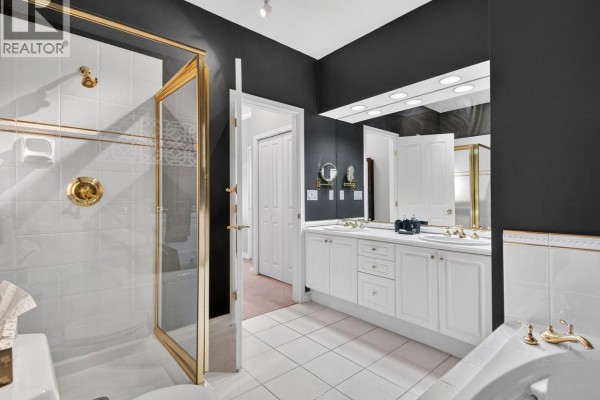 Bathroom with double vanity, walk-in shower with gold trim, and soaking tub. - 29 5221 Oakmount Crescent, Burnaby