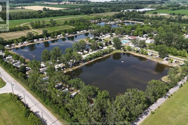 Aerial view of a campground with multiple ponds and RVs. - 29 Apple Lane, Leamington