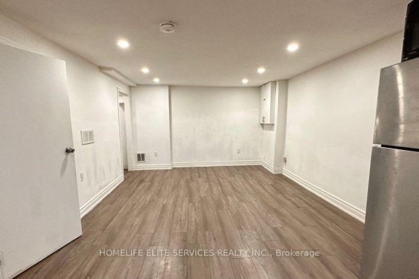 A spacious, empty room with white walls, recessed lighting, and wood-look flooring. - 29 Brightly Drive, Ajax