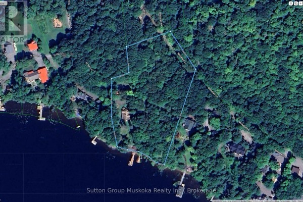 Satellite view of the property boundaries, showing houses and docks within dense woodland by a dark lake. - 29 Island View Lane, Huntsville