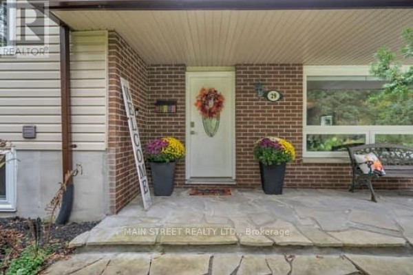 Front door of the house with seasonal decorations and large planters. - 29 Johnston Street, Georgina