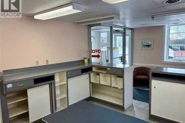 Office area with counter space, light pink walls, and visible entrance - 29 Sixth Avenue N, Yorkton