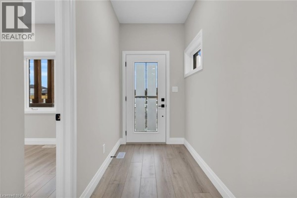 Exterior view of townhouse units with wooden decks in winter. - 29 Weymouth Street Unit# 27, Elmira
