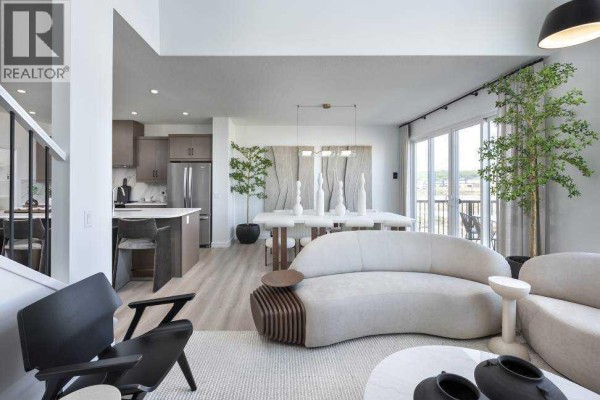 Open concept living room and dining area with kitchen, modern furniture, and sliding doors. - 29 Wolf Hollow Common Se, Calgary