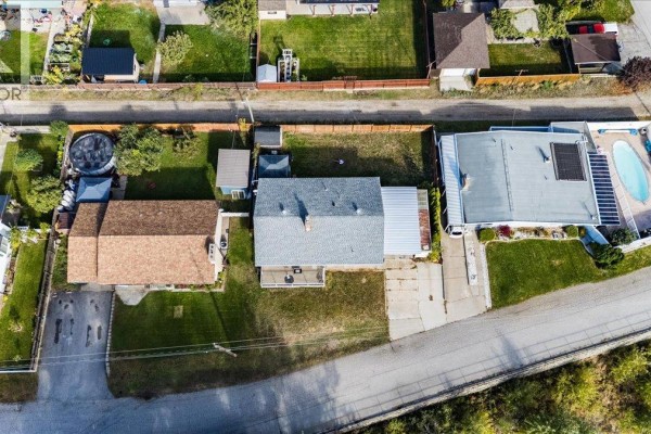 Aerial view of the house and its rectangular lot, surrounded by neighboring properties and a tree-lined street. - 290 8th Avenue, Montrose