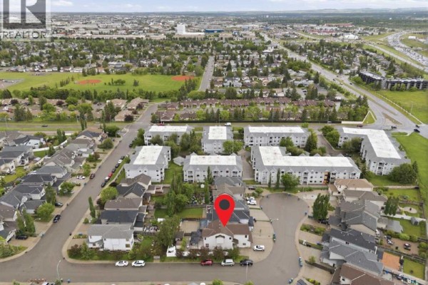 Aerial view of the property showcasing the house, driveway, and surrounding neighbourhood. - 290 Valleyview Court Se, Calgary