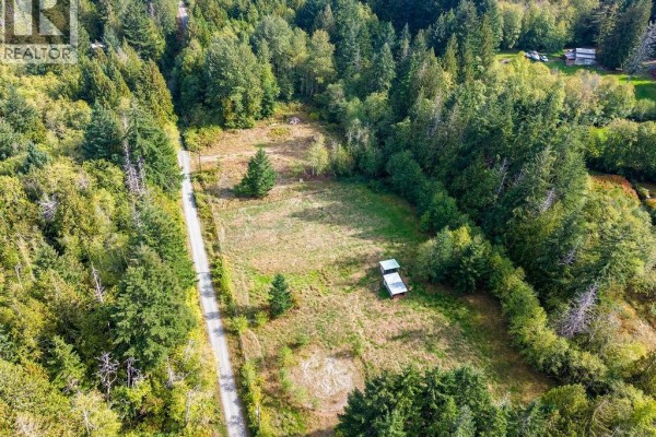 Aerial view of the cleared lot with a dirt road on the left side. - 2900 Amrik Rd, Nanaimo