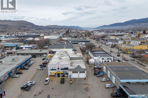 Aerial view of Vernon commercial area showing buildings, streets, and distant mountains. - 2903 43 Avenue, Vernon