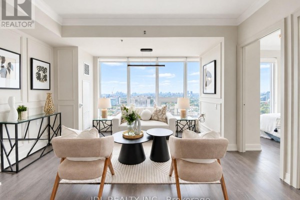 Living room seating area with a sofa, two chairs, and a coffee table facing a large window. - 2904 - 203 College Street, Toronto