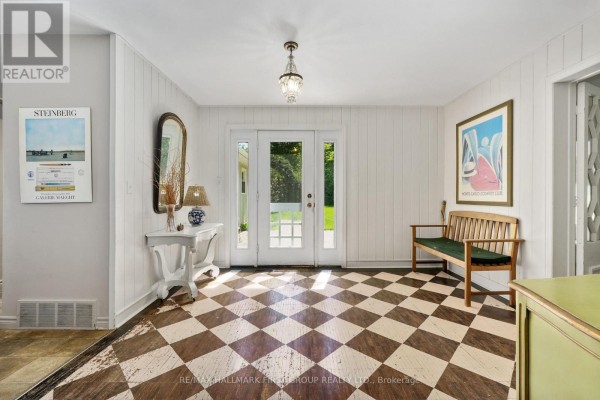 Bathroom with a single vanity, toilet, and a shower with white beadboard. - 2904 Shelter Valley Road, Alnwick/haldimand