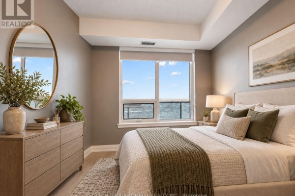 Empty room with grey walls, dark wood floors, and a double door closet. - 2908 - 3600 Highway 7, Vaughan