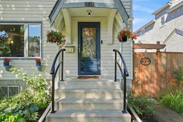 Close-up of the front door entrance with steps and railings. - 291 Campbell Street, Winnipeg