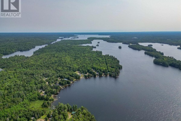 Aerial view of a large lake with forested islands and shoreline homes. - 291 Danis Road, West Nipissing