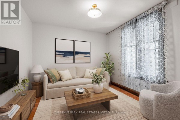 Living room with a beige sofa, armchair, coffee table, television, and two abstract art pieces. - 291 St Helen's Avenue, Toronto