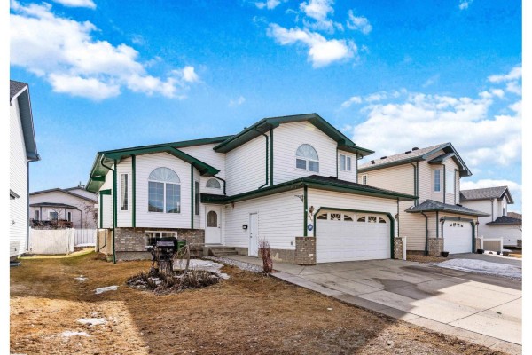 Aerial view of a suburban neighborhood with streets, houses, and a highway running through it. - 2915 151a Av Nw, Edmonton