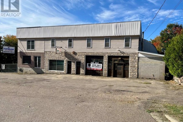 Close-up of the building's facade, showing windows and garage doors. - 292 Bonnechere Street W, Bonnechere Valley