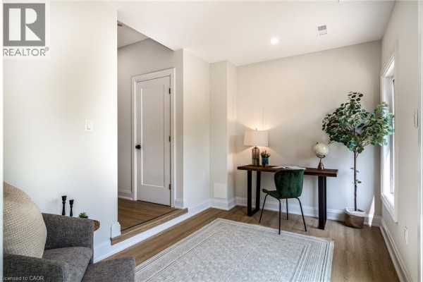 Home office space with a desk, chair, and a large window. - 292 Vine Street Unit# 82, St  Catharines