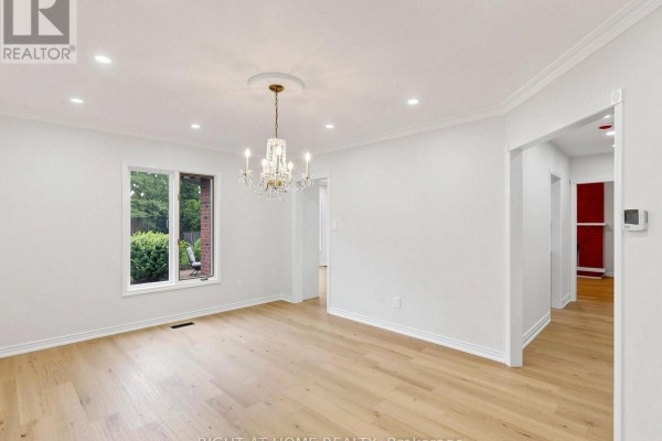 Dining room with hardwood floors and crystal chandelier - 2920 Kingsway Drive Oakville