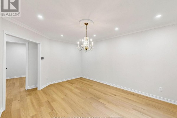 Dining room with hardwood floors and chandelier - 2920 Kingsway Drive Oakville