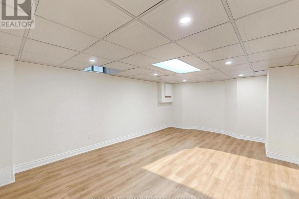 Renovated basement with wood-look flooring and recessed lighting - 2920 Kingsway Drive Oakville