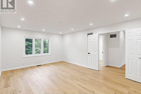 Empty bedroom with hardwood floors and a window - 2920 Kingsway Drive Oakville