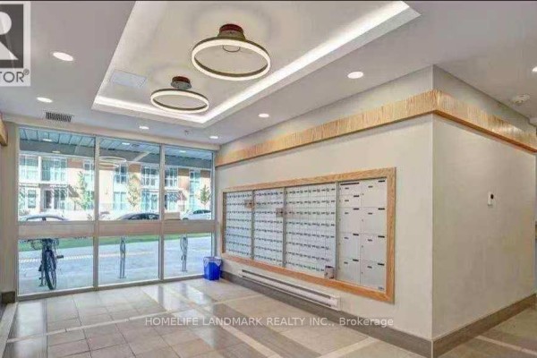 Building lobby with mailboxes, a large window, and modern circular light fixtures. - 293 - 258b Sunview Street, Waterloo