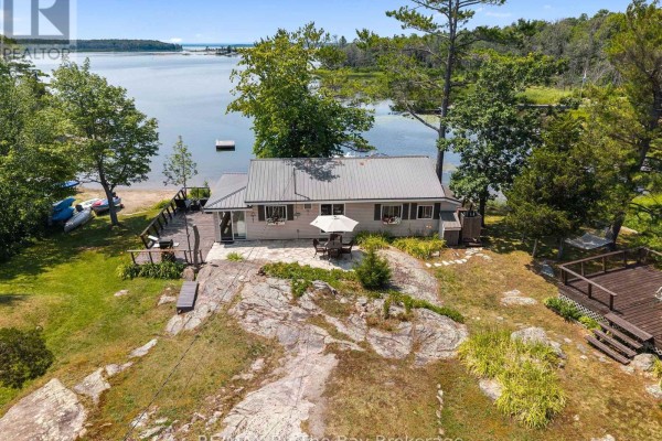 Aerial panorama of Georgian Bay shoreline with scattered houses, docks, and islands under a blue sky. - 294 Prisque Road, Georgian Bay
