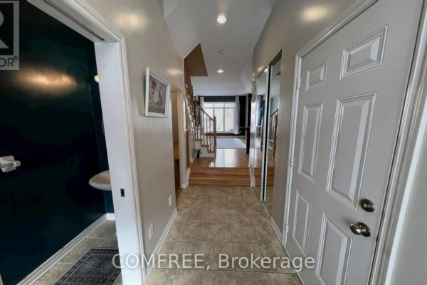 Hallway with tile flooring, staircase, and mirrored closet doors - 294 Waymark Crescent, Ottawa
