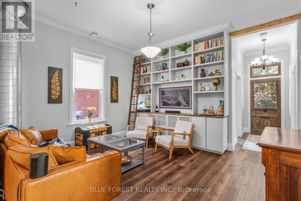 Living room with a large white bookshelf unit, TV, and ladder. - 295 Buller Street, Woodstock