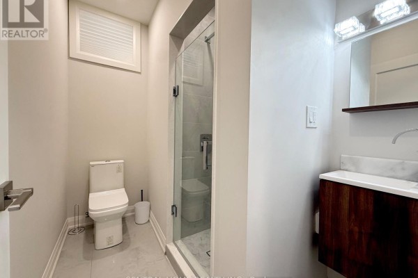 Bathroom featuring a toilet, glass-enclosed shower, and a vanity with a marble countertop. - 2954 Elgin Mills Road E, Markham
