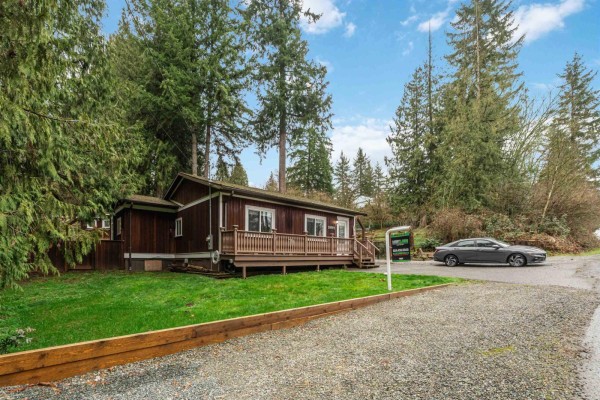 Angle view of the house showcasing the deck and surrounding greenery. - 29791 Silverdale Avenue, Mission