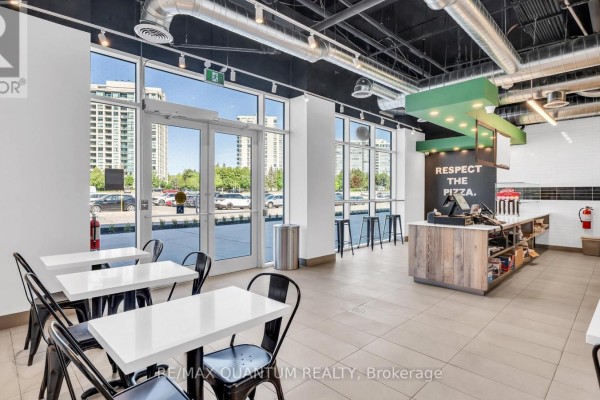 Interior view of a pizza restaurant with counter, tables, and kitchen equipment. - 2a - 1 Promenade Circle, Vaughan