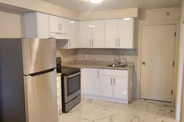 Corner kitchen with white cabinets, granite countertops, and stainless steel appliances. - 2b-3rd Floor - 1030 St Clair Avenue, Toronto