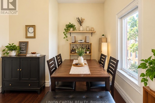 Dining area with a wooden table, chairs, bench, and black sideboard. - 2nd Fl - 459 Queen Street W, Toronto